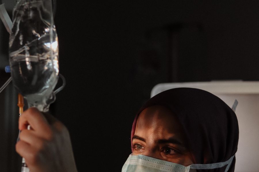 A nurse preparing an intravenous chemotherapy infusion