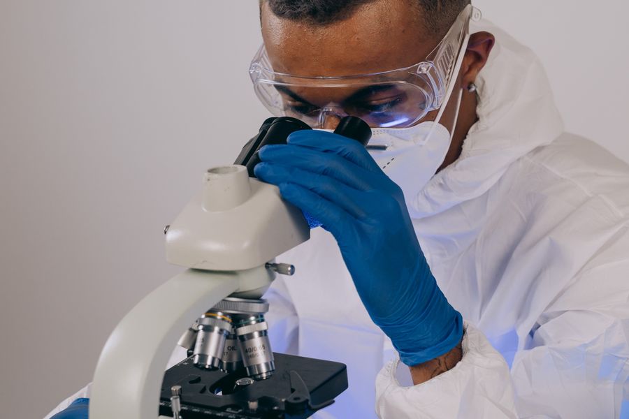 A scientist examining a sample under a microscope